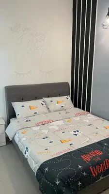 a bed with a comforter and pillows on it at Sweet Homestay 3RM @ Penthouse Apartment in Brinchang in Brinchang