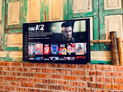 a flat screen tv on a brick wall at INS White House Ipoh in Ipoh