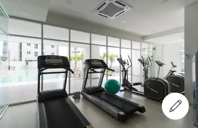 a gym with treadmills and exercise bikes in a room at Deluxe Suites 5, 2-4 pax , Netflix, Georgetown in Jelutong