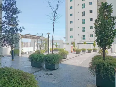 a courtyard with potted trees in front of a building at Deluxe Suites 5, 2-4 pax , Netflix, Georgetown in Jelutong