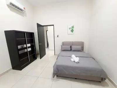 a bedroom with a bed with a white pillow on it at JOVIAL SingleStorey Bungalow 4Room10Pax `Alma in Bukit Mertajam