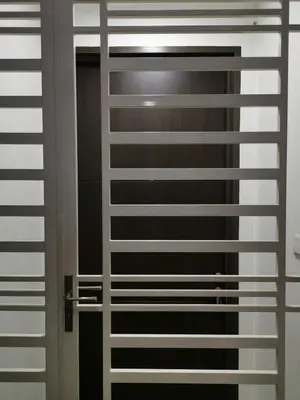 a window with white blinds on a door at Strait Garden Family Suites by Maj in Jelutong