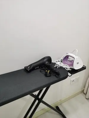a black table with a phone on top of it at Strait Garden Family Suites by Maj in Jelutong
