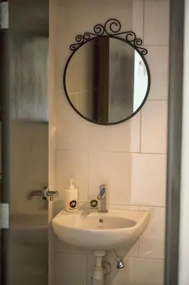 a bathroom with a sink and a mirror on the wall at The Majestic Ipoh Town - Mountain View in Ipoh