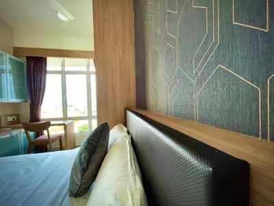 a bedroom with a bed with a leather head board at The Majestic Ipoh Town - Mountain View in Ipoh