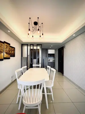 a dining room with a white table and white chairs at The Majestic Ipoh Town - Mountain View in Ipoh