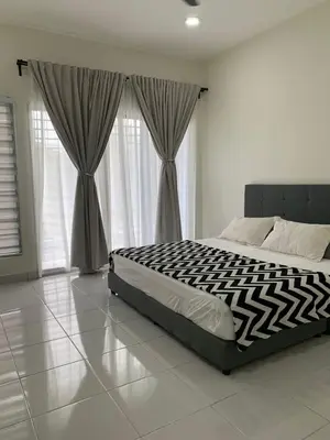 a bedroom with a black and white bed with curtains at Juwita&Arjuna Homestay Teluk Senangin in Kampong Batu Tiga