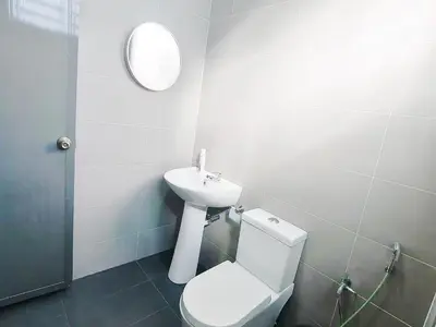 a bathroom with a white toilet and a sink at Marvelous Homestay SP Kedah in Sungai Petani