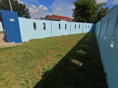 a long fence with a row of houses at Marvelous Homestay SP Kedah in Sungai Petani