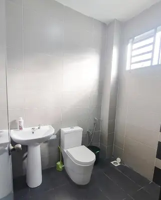 a bathroom with a white toilet and a sink at Marvelous Homestay SP Kedah in Sungai Petani
