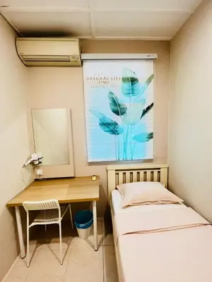 a small room with a desk and a painting on the wall at myRoom Georgetown, Off Jalan Burma, Gurney Drive in George Town
