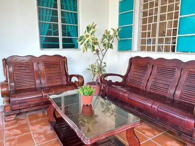 two brown leather benches sitting on a glass table at myRoom Georgetown, Off Jalan Burma, Gurney Drive in George Town