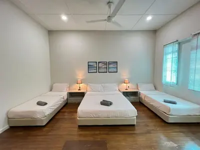a room with two beds and two tables with lamps at myRoom Georgetown, Off Jalan Burma, Gurney Drive in George Town