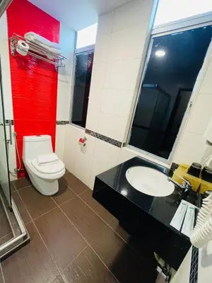 a bathroom with a white toilet and a sink at K Garden Hotel Parit Buntar in Parit Buntar