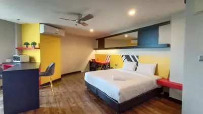 a hotel room with a bed and a desk at Sense Hotel Taiping in Taiping