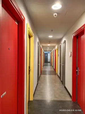 a corridor in an office building with colorful doors at Sense Hotel Taiping in Taiping