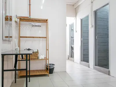 a bathroom with a black table and white tiles at Aayu Chulia - Chulia St, George Town in George Town