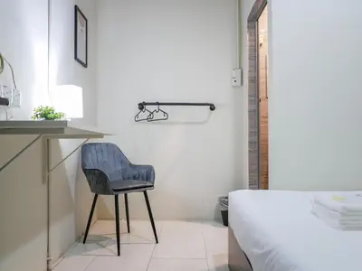 a bedroom with a desk and a chair next to a bed at Aayu Chulia - Chulia St, George Town in George Town