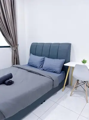 a bed with blue pillows and a table in a room at TheSun #3BR #PISA #FTZ #FamilyStay #USM in Bayan Lepas
