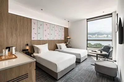 a hotel room with two beds and a desk at Crowne Plaza Penang Straits City by IHG in Perai