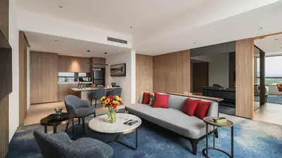 a living room with a couch and chairs at Crowne Plaza Penang Straits City by IHG in Perai