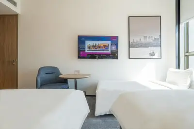 a hotel room with two beds and a tv on the wall at Crowne Plaza Penang Straits City by IHG in Perai