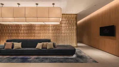 a living room with a black couch in a lobby at Crowne Plaza Penang Straits City by IHG in Perai