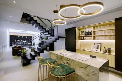 a lobby with a bar and a staircase with wine glasses at Georgetown Luxury Heritage House 4BR 10Pax in George Town