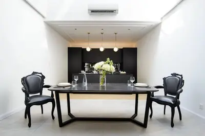a dining room with a table and black chairs at Georgetown Luxury Heritage House 4BR 10Pax in George Town