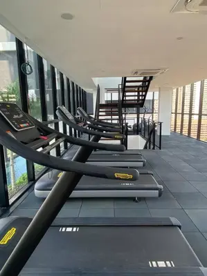 a gym with a row of treadmills and chairs at Urban Suites Georgetown, Penang in Jelutong