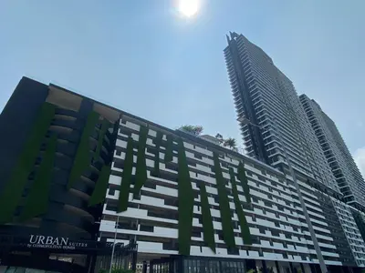 a large building with two tall buildings behind it at Urban Suites Georgetown, Penang in Jelutong