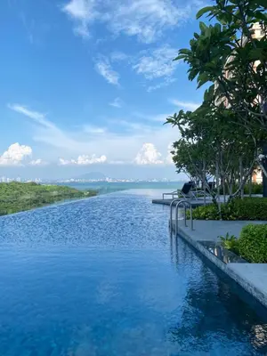 a swimming pool with a view of a body of water at Urban Suites Georgetown, Penang in Jelutong