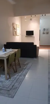 a living room with a table and a couch at Ain's Homestay Muslim friendly Kuala Kubu Bharu in Kuala Kubu Baharu
