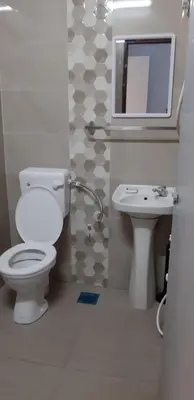 a bathroom with a toilet and a sink and a mirror at Ain's Homestay Muslim friendly Kuala Kubu Bharu in Kuala Kubu Baharu