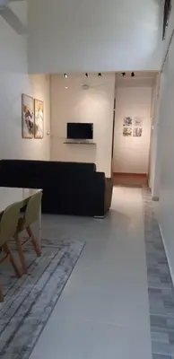 a living room with a table and a couch at Ain's Homestay Muslim friendly Kuala Kubu Bharu in Kuala Kubu Baharu
