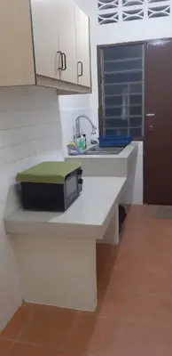 a kitchen with a sink and a microwave at Ain's Homestay Muslim friendly Kuala Kubu Bharu in Kuala Kubu Baharu