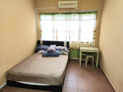 a small bedroom with a bed and a window at Reyza Homestay KKB in Kuala Kubu Baharu