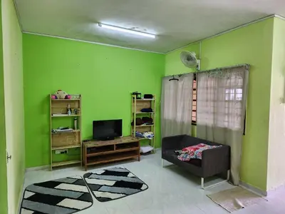 a living room with green walls and a television at Reyza Homestay KKB in Kuala Kubu Baharu