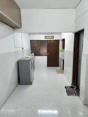 an empty room with ailed hallway with a refrigerator at Reyza Homestay KKB in Kuala Kubu Baharu