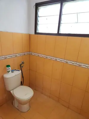 a bathroom with a toilet and a window at Reyza Homestay KKB in Kuala Kubu Baharu
