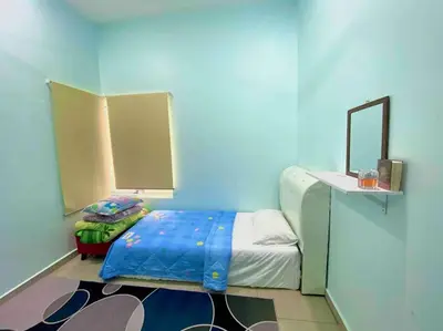 a blue room with a bed and a mirror at Homestay Naim Sabak Bernam in Sabak Bernam