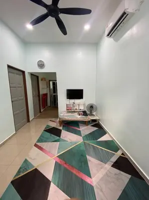 a living room with a ceiling fan and a colorful floor at Homestay Naim Sabak Bernam in Sabak Bernam