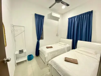 a hospital room with two beds and a mirror at Rumah Inap Che'Gu Baha in Teluk Intan