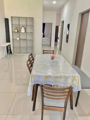 a dining room table with a yellow and white table cloth at Rumah Inap Che'Gu Baha in Teluk Intan