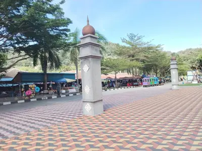 a pillar with a ball on it on a street at Teluk Batik Holiday Apartment in Lumut