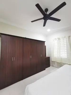 a bedroom with a ceiling fan and wooden cabinets at Ipoh stadium 1min/wahkeongpark simee 18pax bungalow cottage in Ipoh