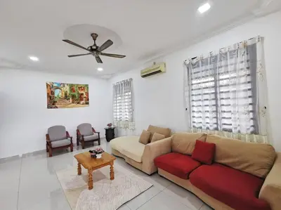 a living room with a couch and a ceiling fan at Ipoh stadium 1min/wahkeongpark simee 18pax bungalow cottage in Ipoh