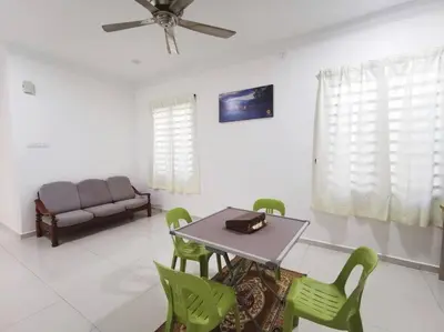 a dining room with a table and chairs and a couch at Ipoh stadium 1min/wahkeongpark simee 18pax bungalow cottage in Ipoh