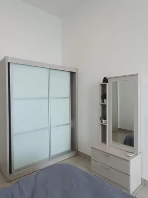 a bedroom with a large window and a mirror at Seaview Condo 10pax #10minQueensbay #15minSpice in Bayan Lepas