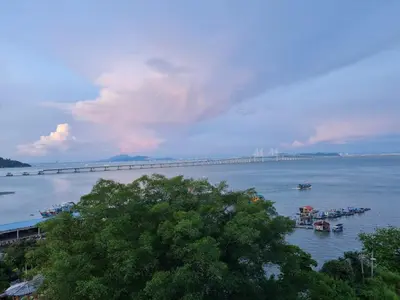 a bridge over a large body of water with boats at Seaview Condo 10pax #10minQueensbay #15minSpice in Bayan Lepas